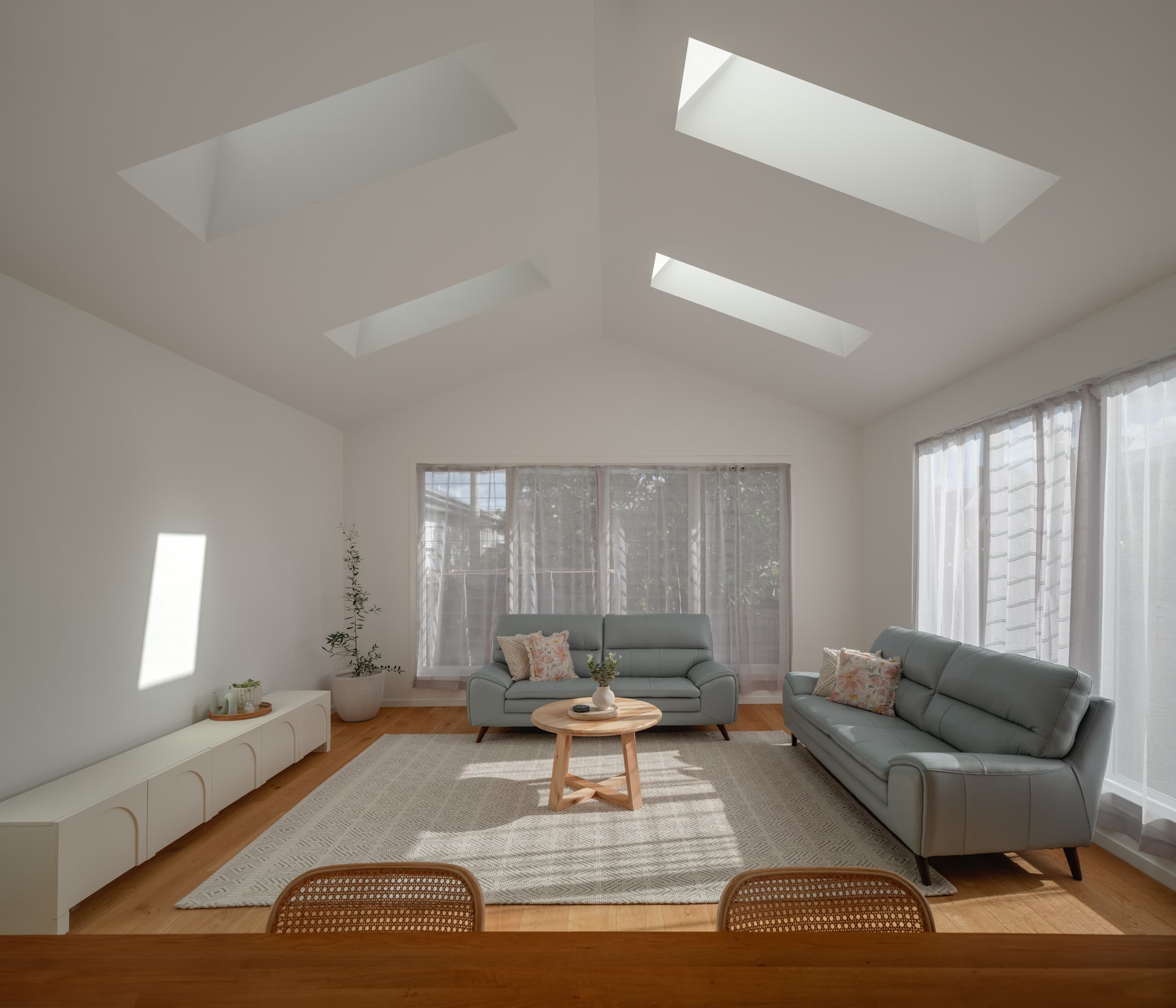 Harding House living room under a raked ceiling with four long skylights
