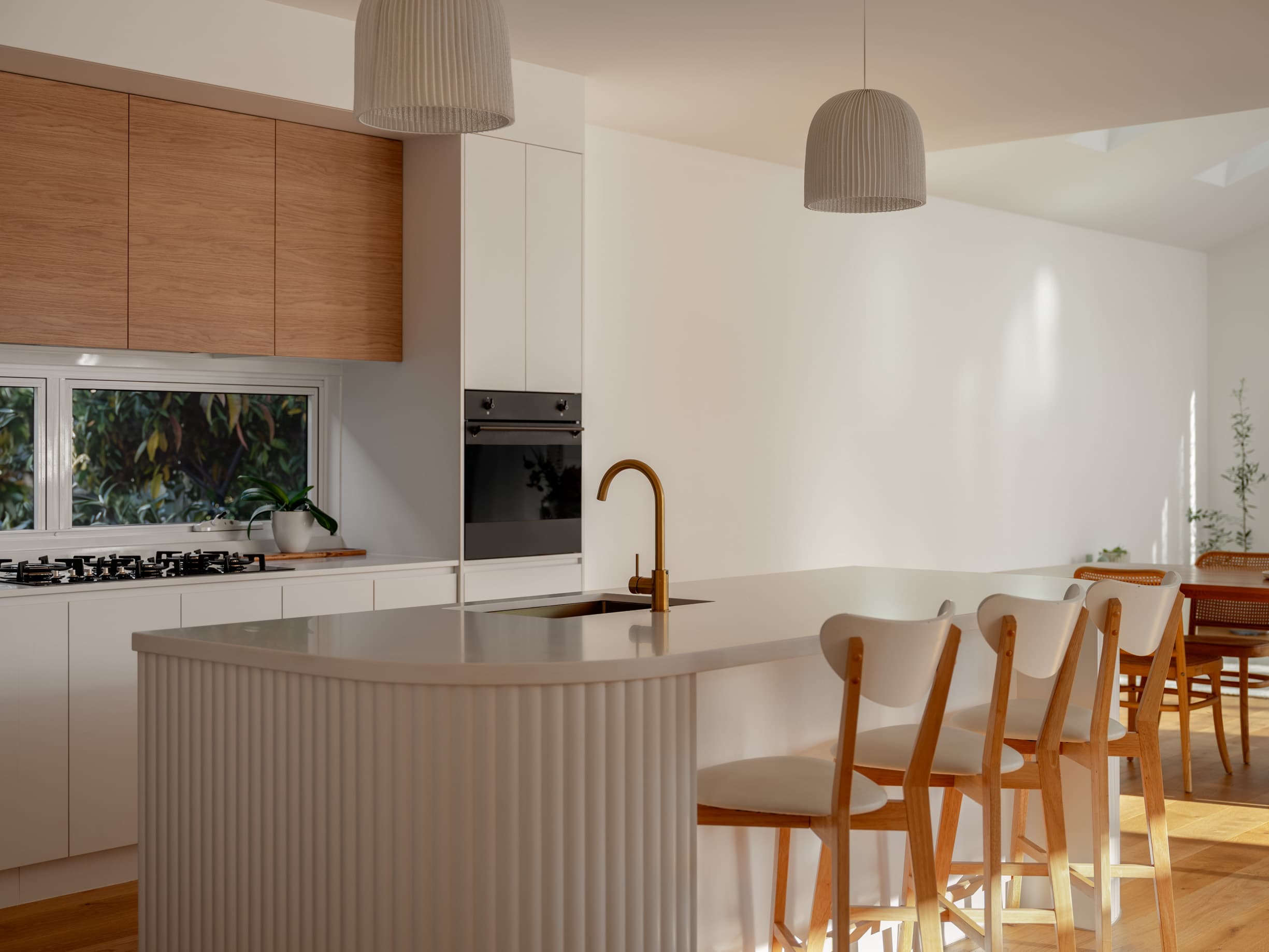 Harding House kitchen island with a fluted base and brass tapware