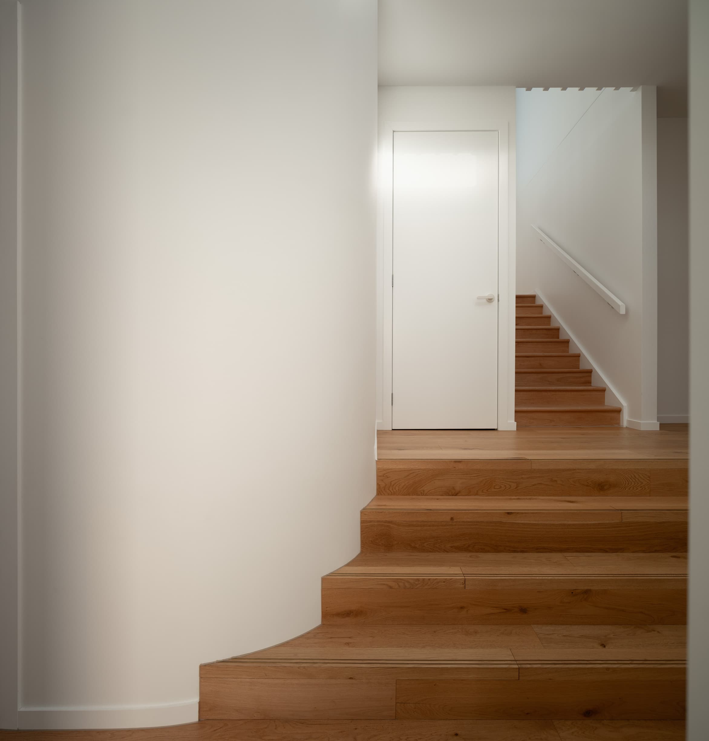 Harding House curved wall beside broad oak steps rising to the stair