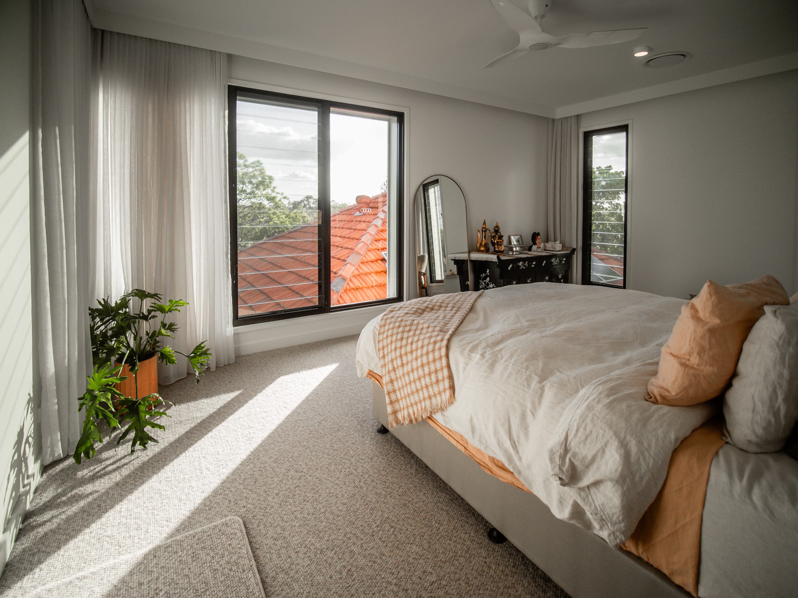Jacaranda Highside upstairs bedroom with tall windows over neighbouring rooftops
