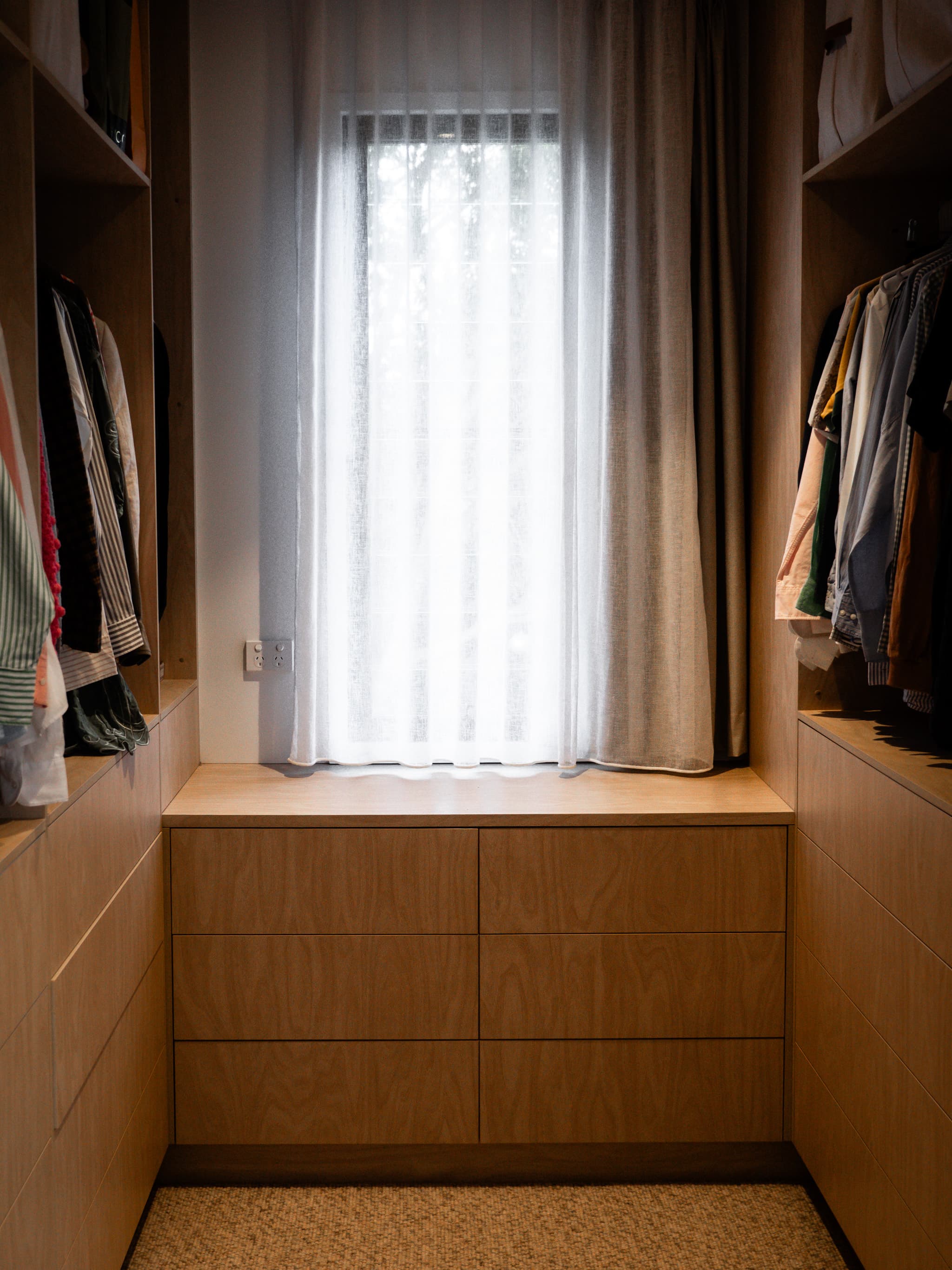 Jacaranda Highside walk-in robe with timber joinery and a curtained window seat