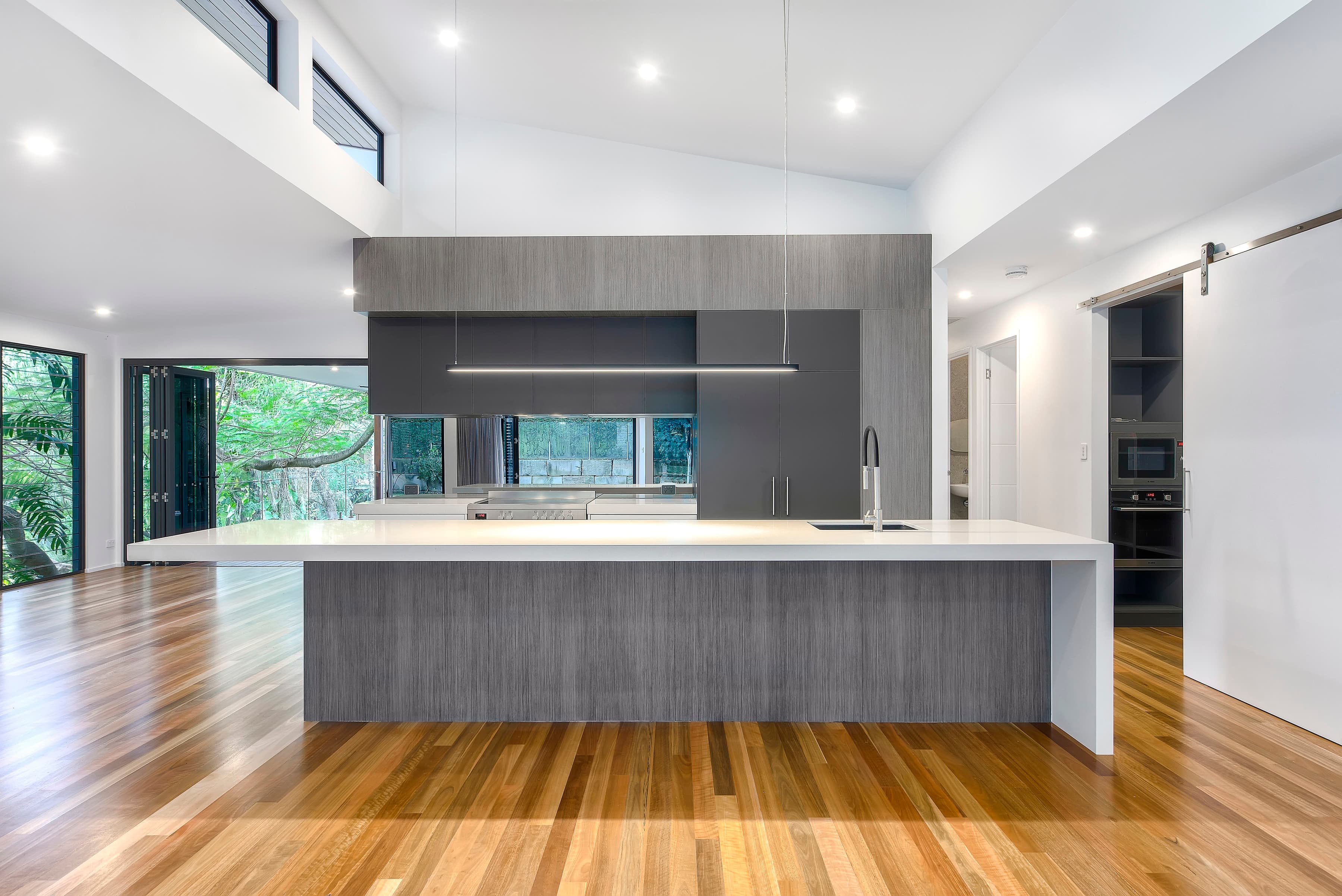 Langside Road kitchen with a long island under a raked ceiling and clerestory windows