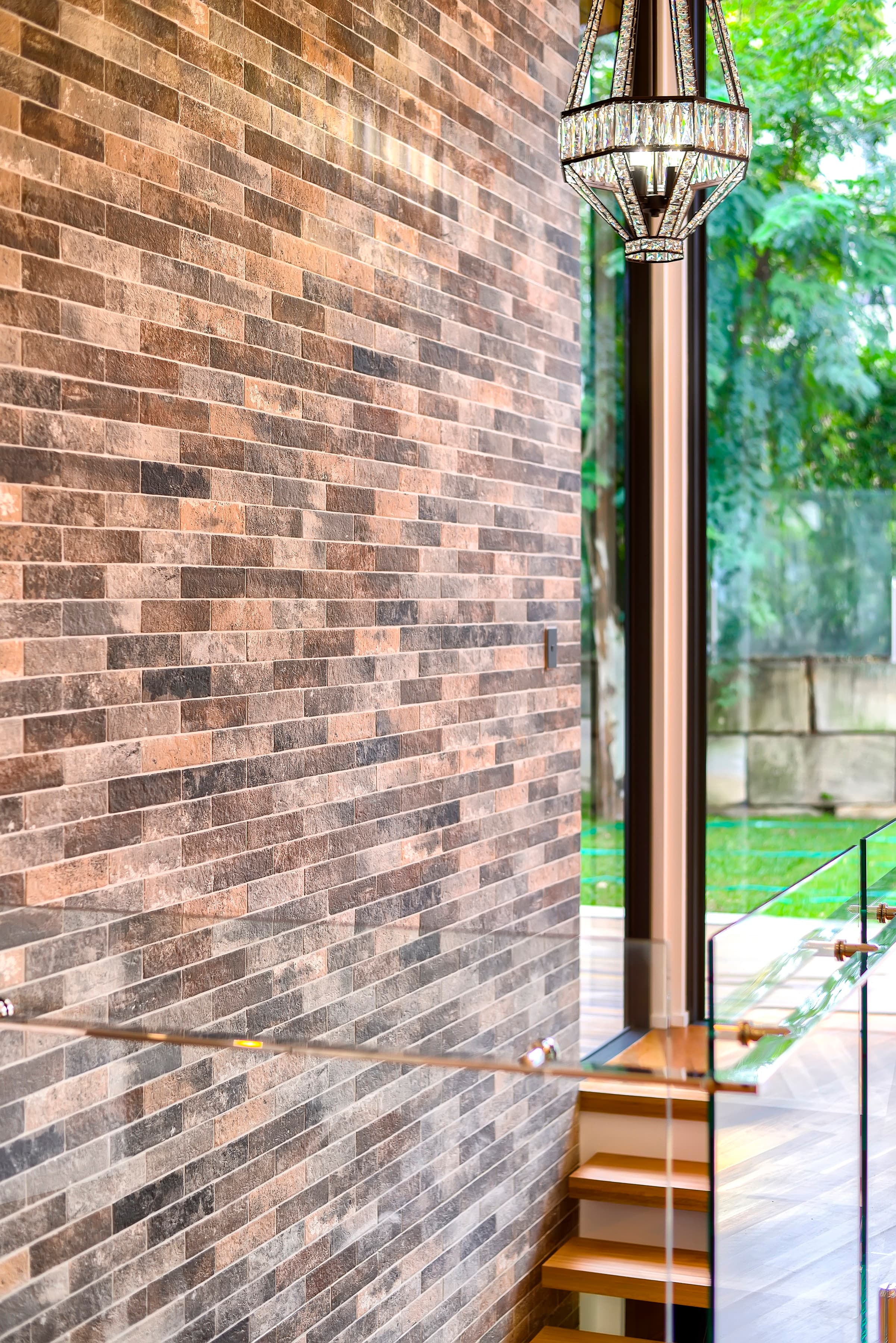 Langside Road brick feature wall beside the glass-balustraded stair