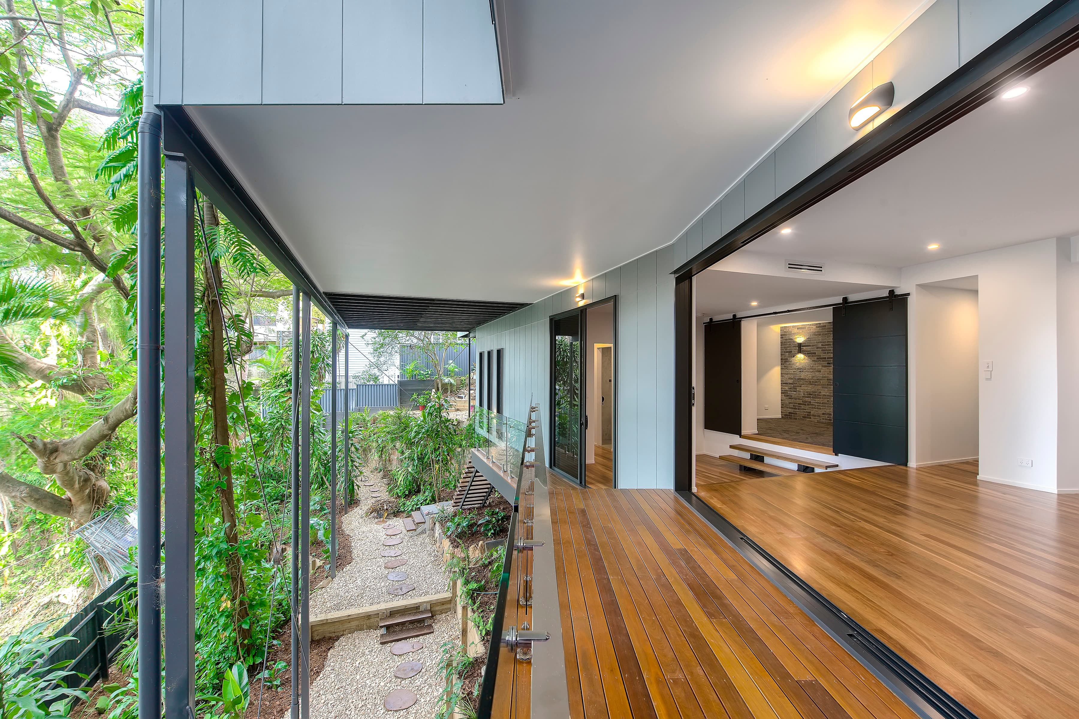 Langside Road covered walkway beside the planted gully, opening into the living room