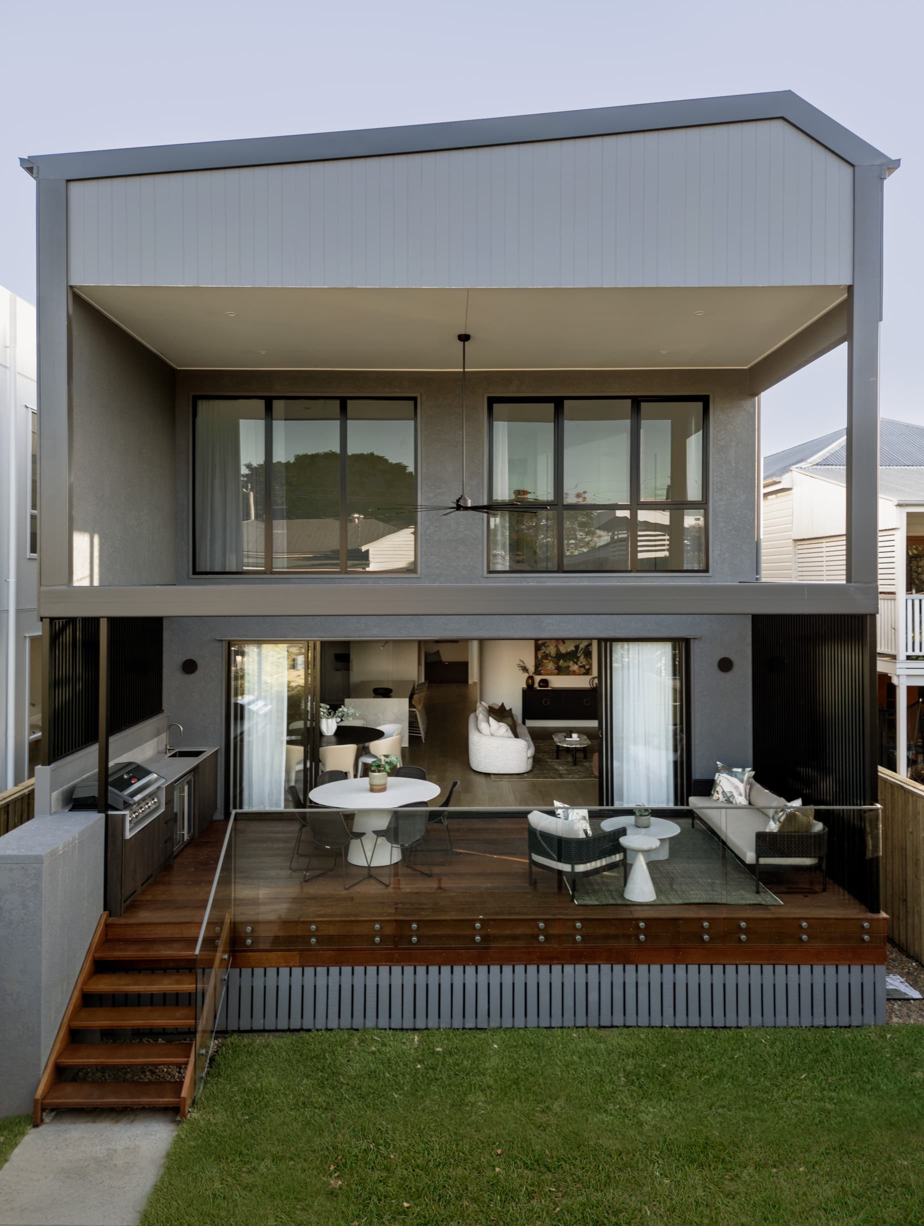 Lindsay House rear elevation with the upper storey cantilevered over the deck and lawn