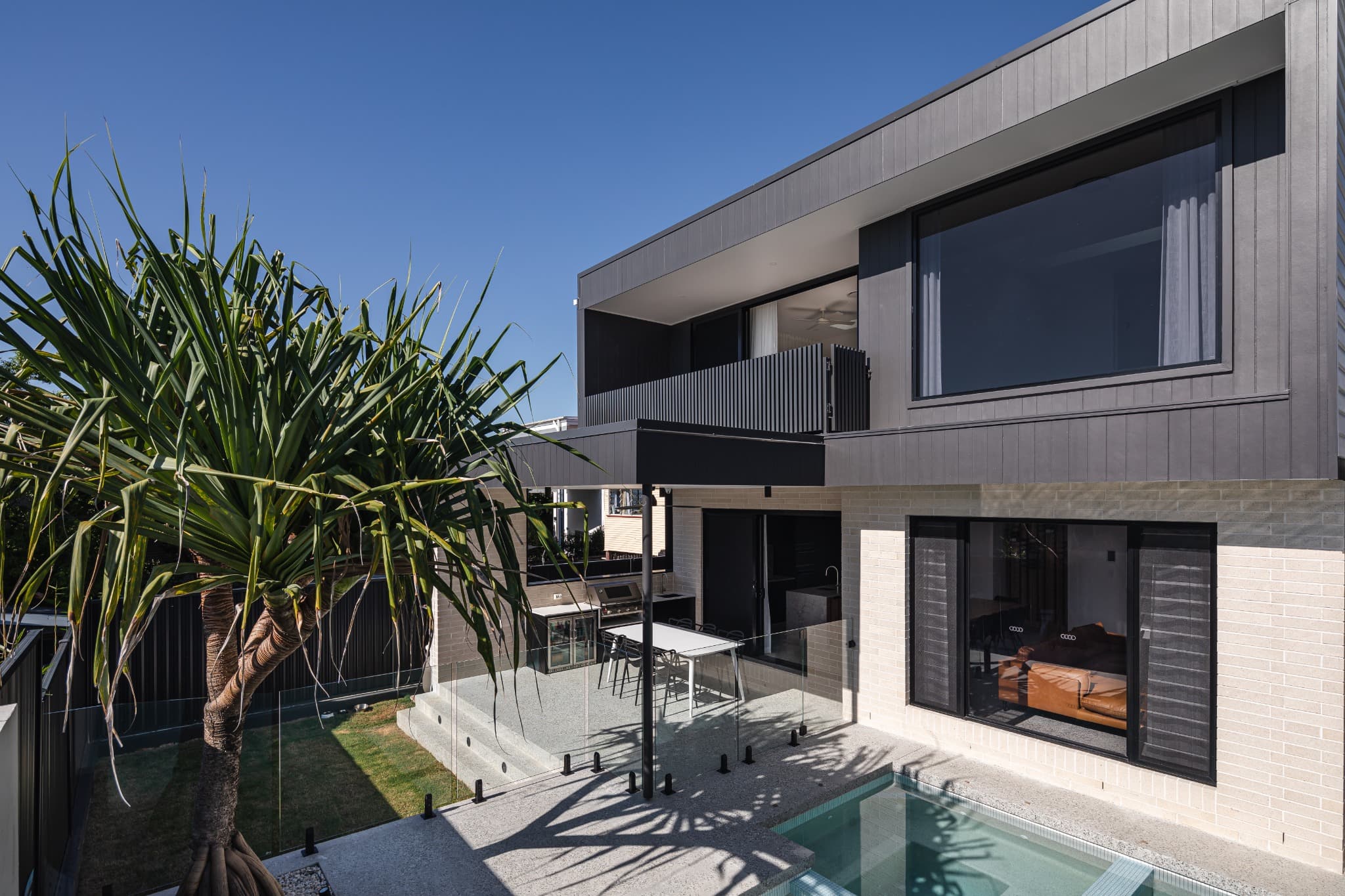 Melville Terrace pool courtyard with pandanus, an outdoor kitchen and dining