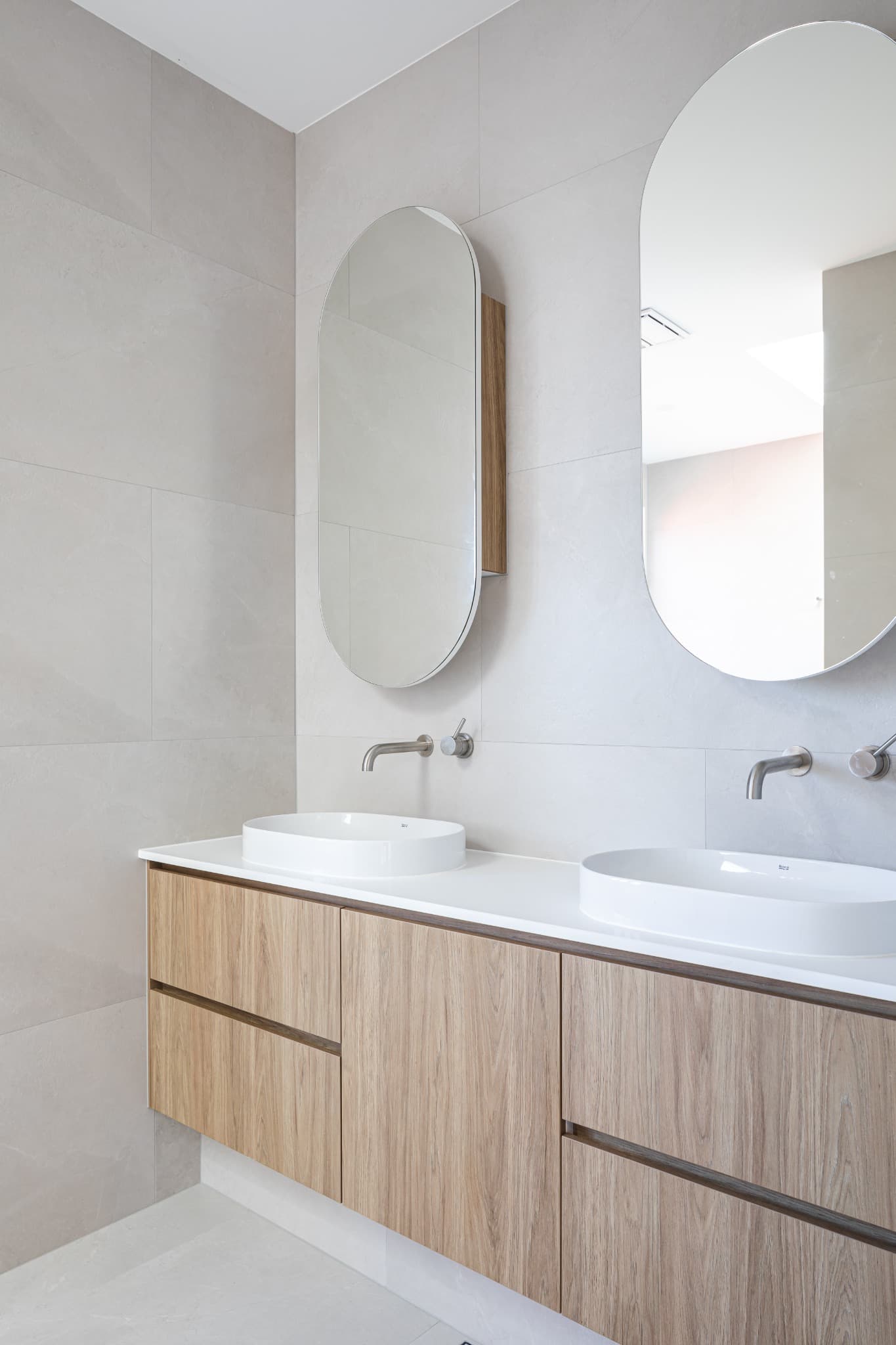 Melville Terrace twin vanity with oval mirrors and timber joinery