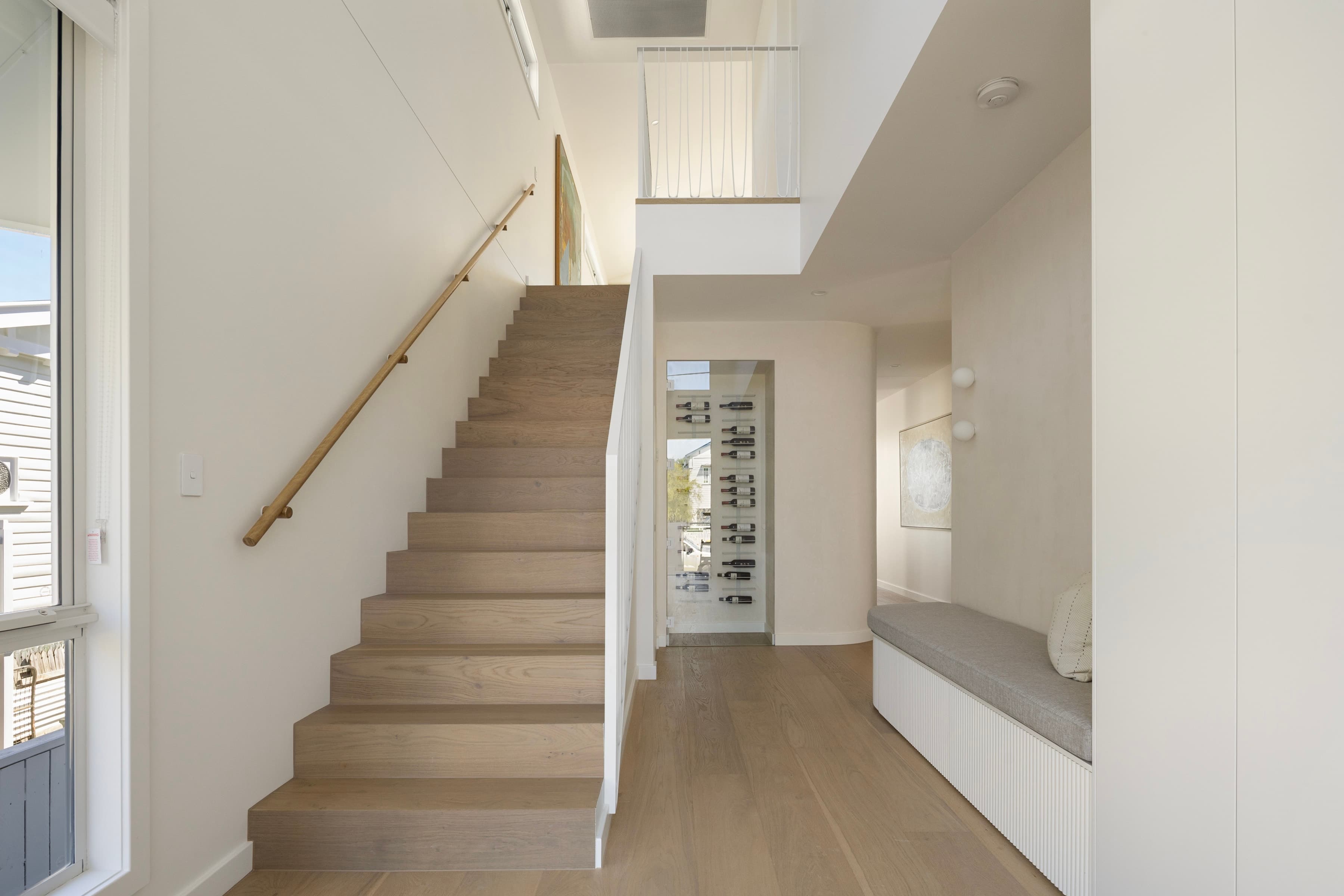 Mesa entry hall with an oak stair, window seat and glazed wine store