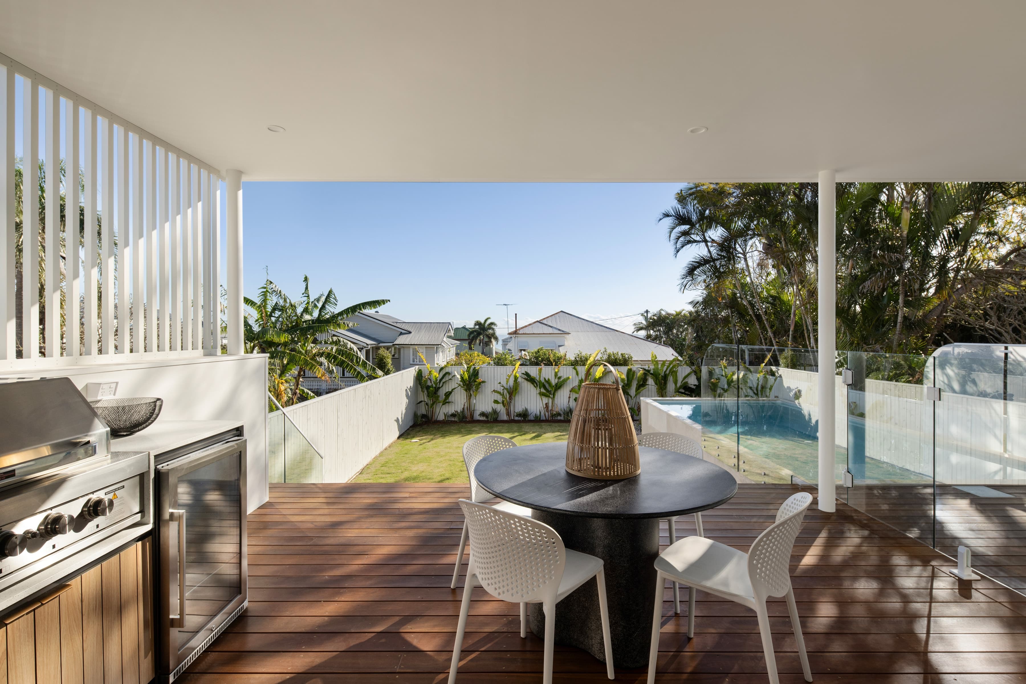 Mesa lower deck with an outdoor kitchen looking across the pool and lawn