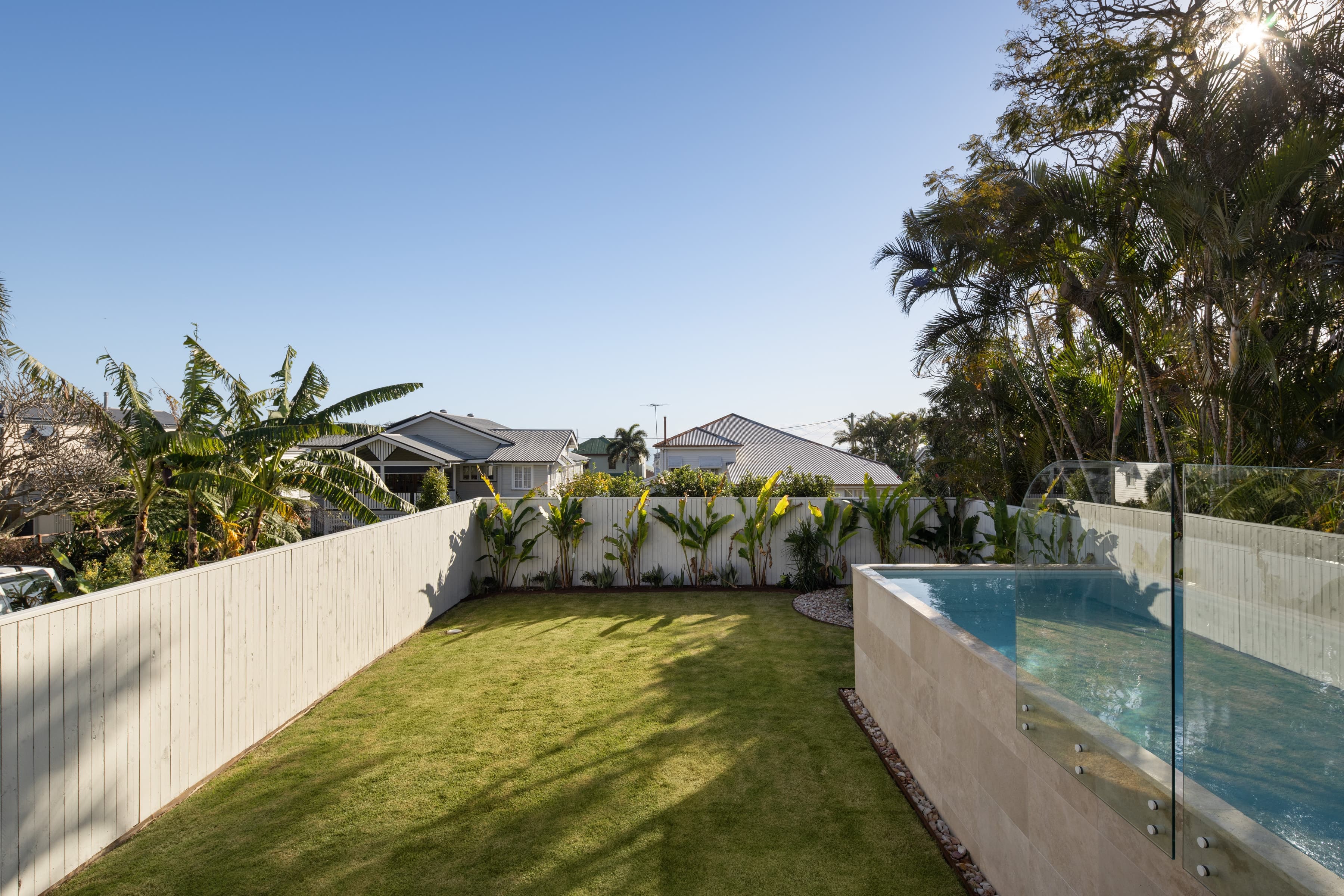 Mesa rear lawn and raised pool screened by banana palms