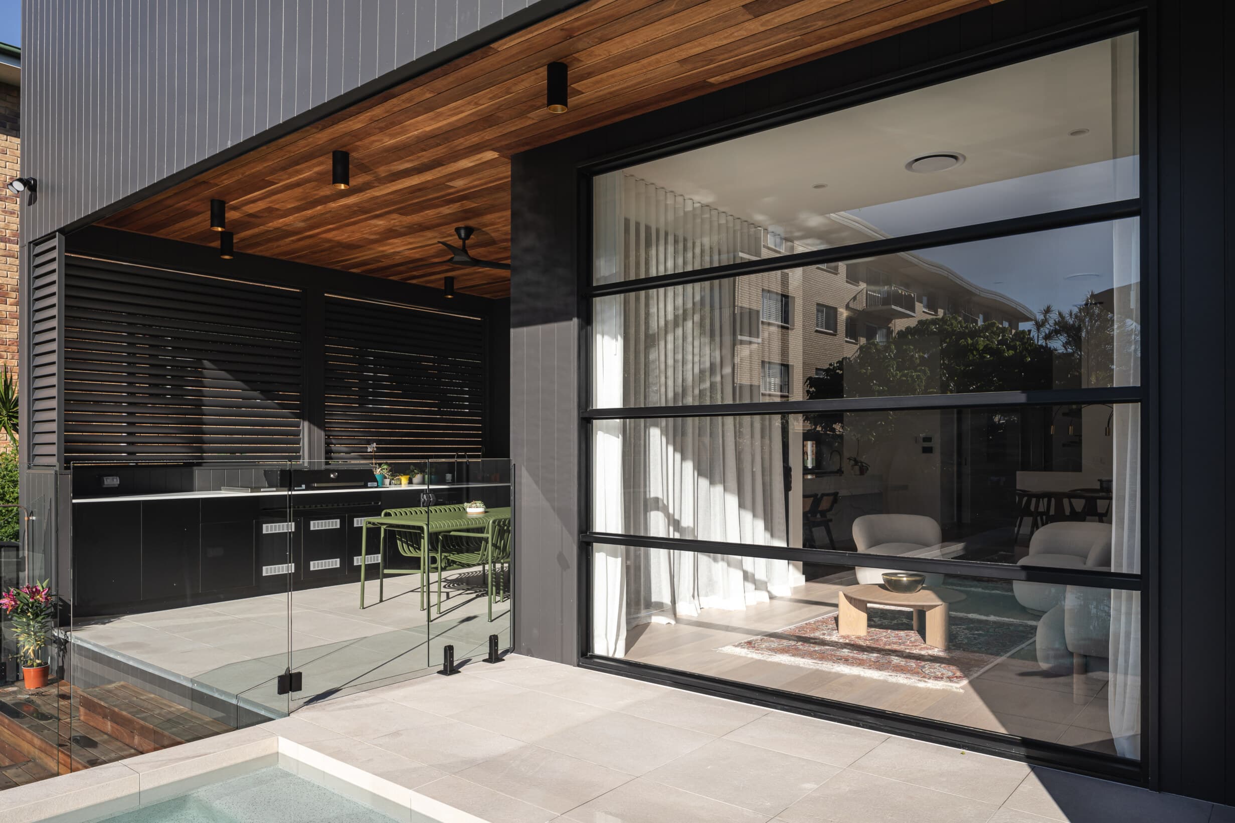 Z House covered outdoor kitchen and dining beside the pool